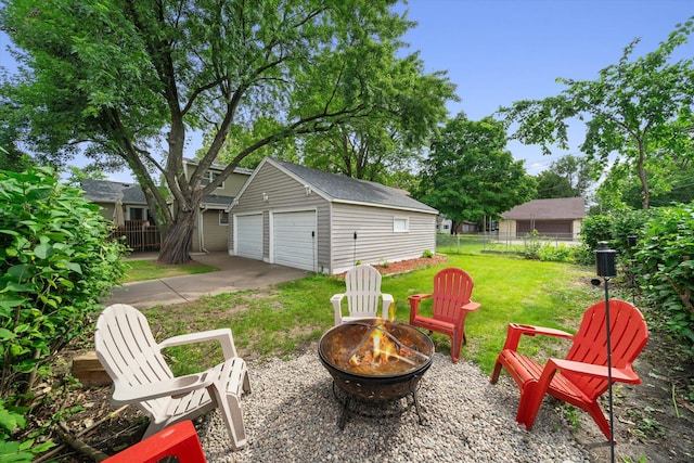 view of patio featuring an outbuilding, an outdoor fire pit, and a garage