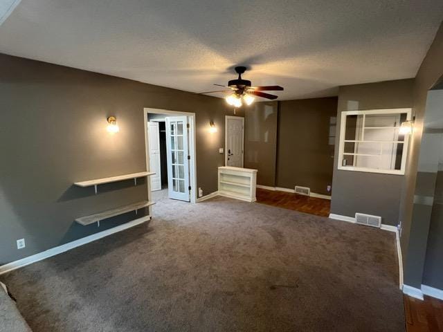 unfurnished living room featuring ceiling fan, french doors, and carpet floors