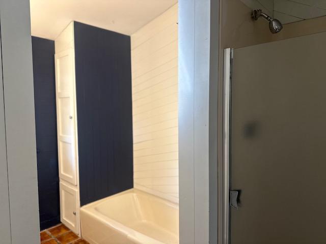 bathroom with shower / washtub combination and tile patterned flooring