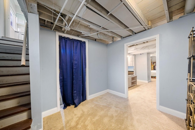 basement featuring light colored carpet