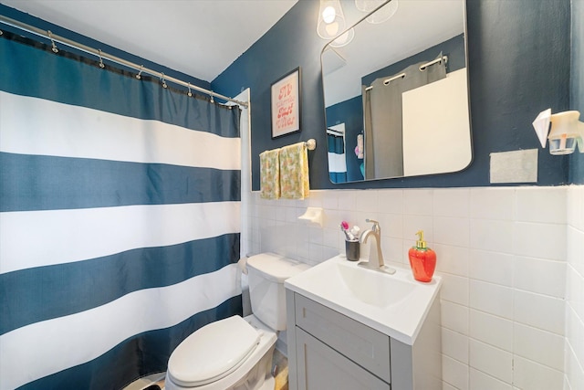 bathroom featuring vanity, decorative backsplash, toilet, and tile walls