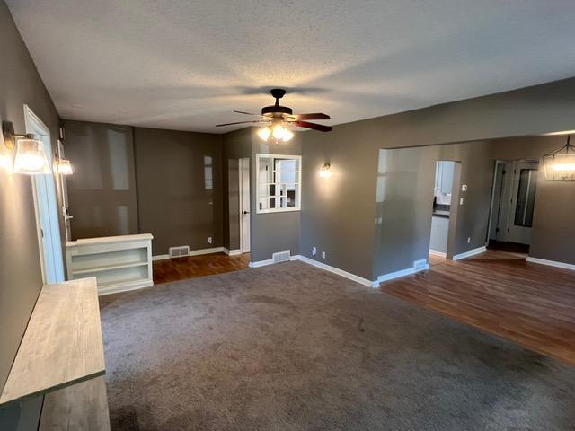 interior space with ceiling fan and a textured ceiling