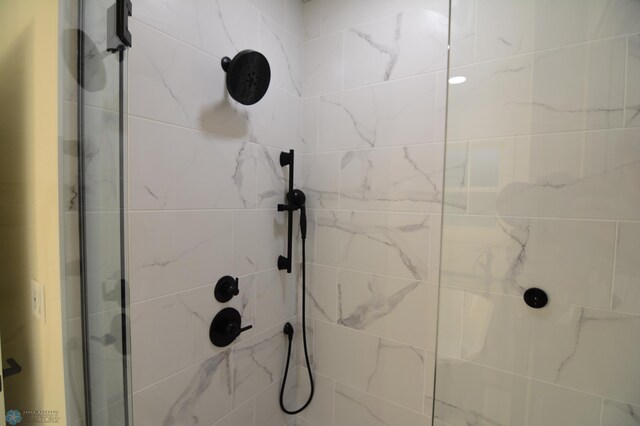 bathroom with tiled shower