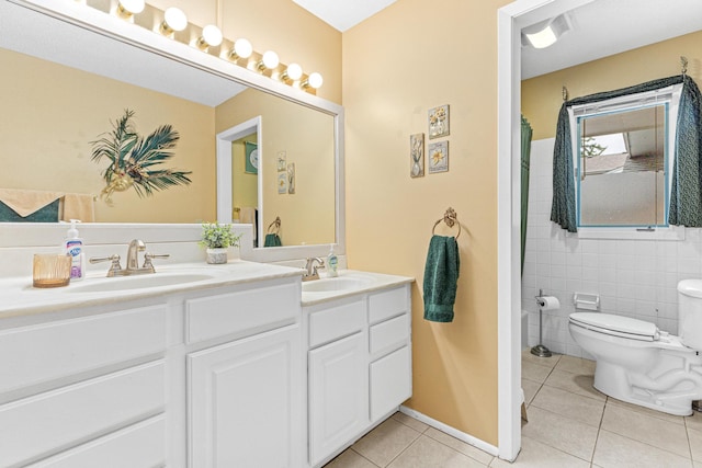 750 Carla Ln, Little Canada, MN 55109 - full bathroom featuring tile patterned flooring, double vanity, toilet, and tile walls