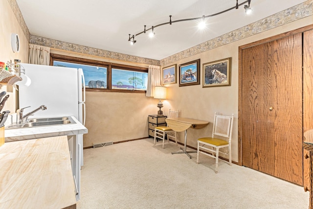 750 Carla Ln, Little Canada, MN 55109 - living area featuring carpet, baseboards, rail lighting, and wallpapered walls
