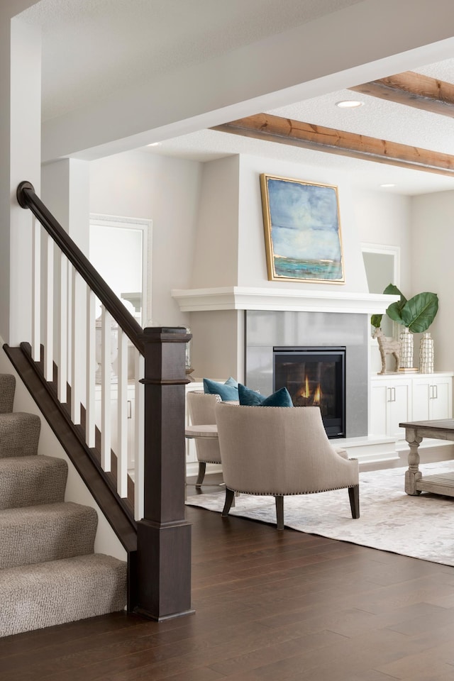 living room with beamed ceiling and dark hardwood / wood-style flooring