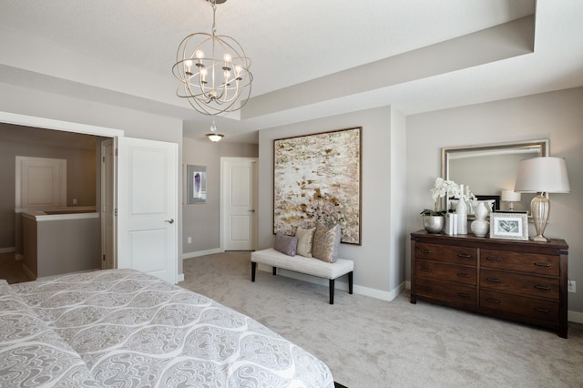 bedroom with a tray ceiling, a notable chandelier, and light colored carpet