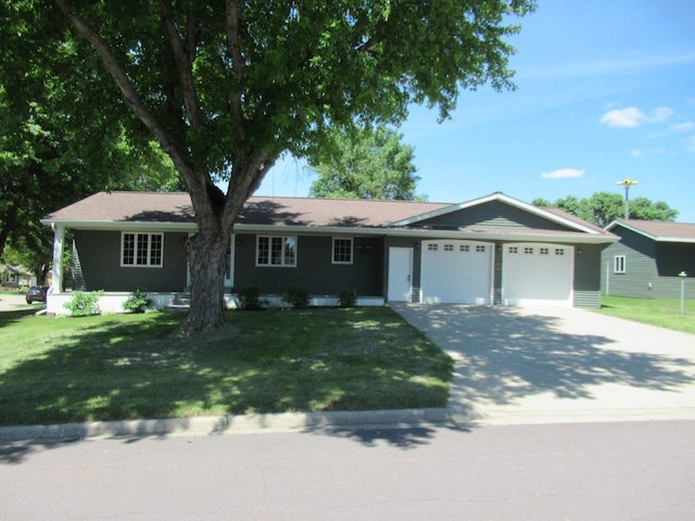 single story home with a garage and a front lawn