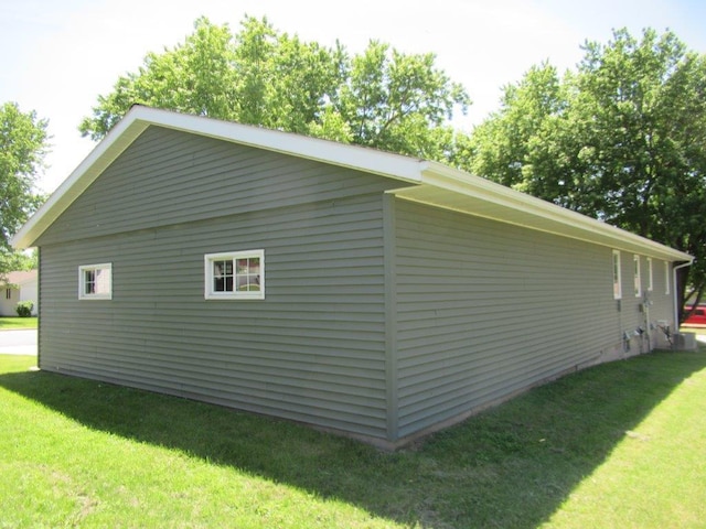 view of side of property with a yard