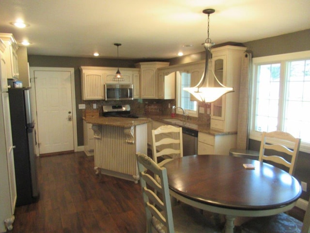 dining area featuring dark hardwood / wood-style flooring and sink