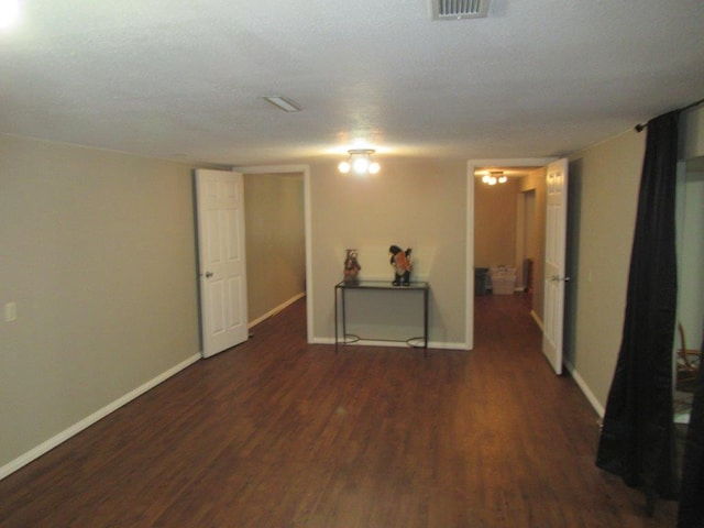 empty room featuring dark wood-type flooring