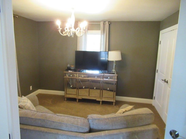 carpeted living room featuring a chandelier