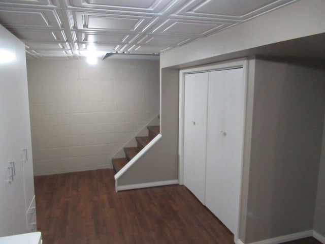 basement with dark hardwood / wood-style flooring