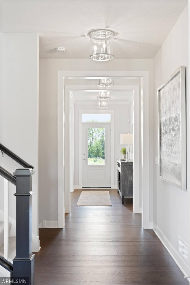 6528 Timber Arch Dr, Chaska, MN 55318 - foyer with dark wood-style flooring, visible vents, baseboards, and a notable chandelier