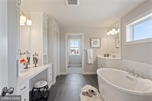 6528 Timber Arch Dr, Chaska, MN 55318 - full bathroom with vanity, a wealth of natural light, a soaking tub, and visible vents