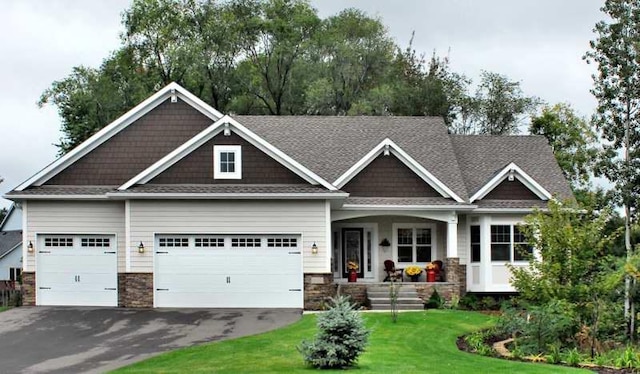 craftsman-style house featuring a garage and a front yard