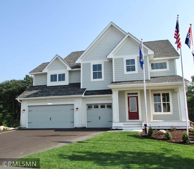 view of front facade with a front yard and a garage