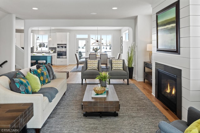 living room with hardwood / wood-style floors and an inviting chandelier