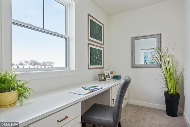 carpeted home office with built in desk