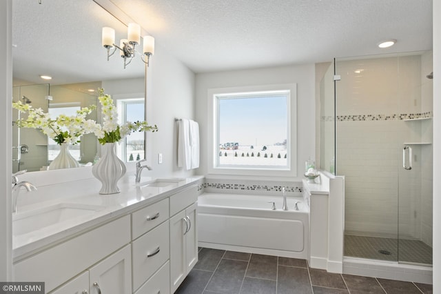 bathroom with tile patterned flooring, plenty of natural light, and a textured ceiling