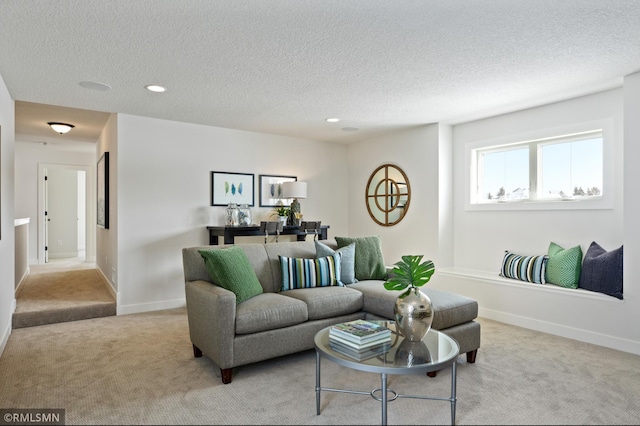 carpeted living room featuring a textured ceiling