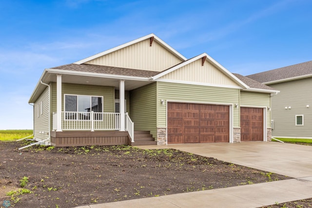 view of front of home featuring a porch and a garage