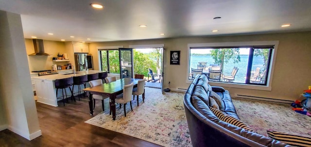 dining room featuring recessed lighting, wood finished floors, baseboards, and baseboard heating