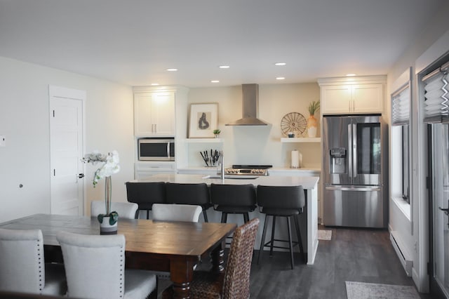 dining room with dark wood finished floors and recessed lighting