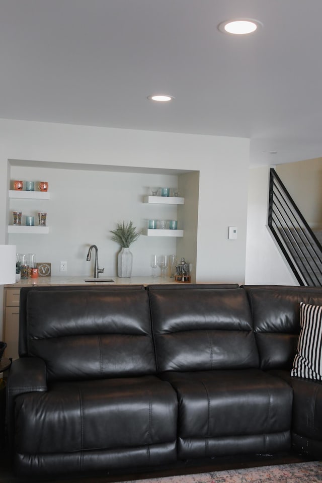 living area featuring wet bar, stairway, and recessed lighting