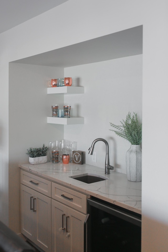 bar with beverage cooler, indoor wet bar, and a sink