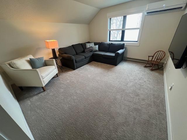 carpeted living room featuring an AC wall unit and vaulted ceiling