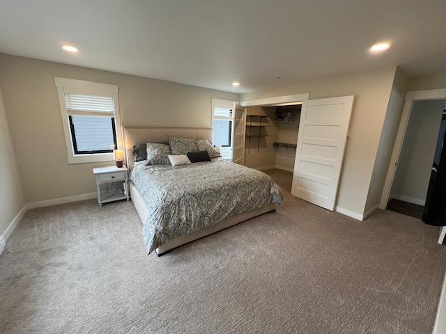 bedroom featuring multiple windows, recessed lighting, baseboards, and carpet floors