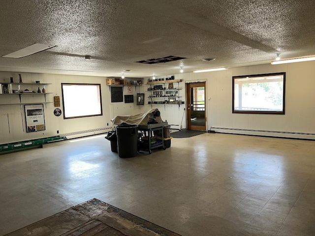 interior space with baseboard heating and a textured ceiling