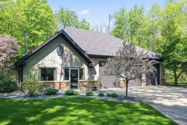 view of front of house featuring a front lawn, stucco siding, concrete driveway, stone siding, and a garage