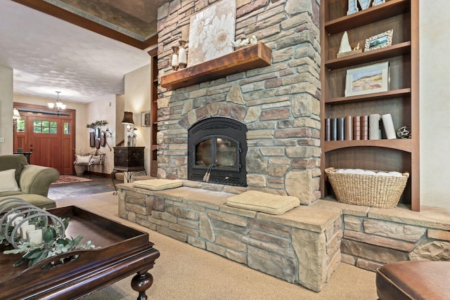 living room with a fireplace, carpet floors, and an inviting chandelier