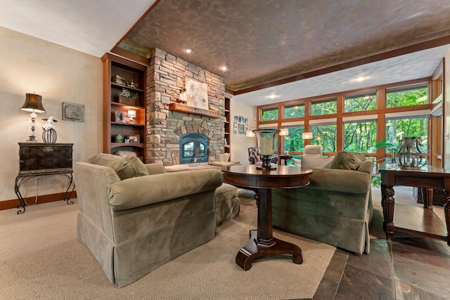 living area with recessed lighting, a stone fireplace, built in shelves, and baseboards