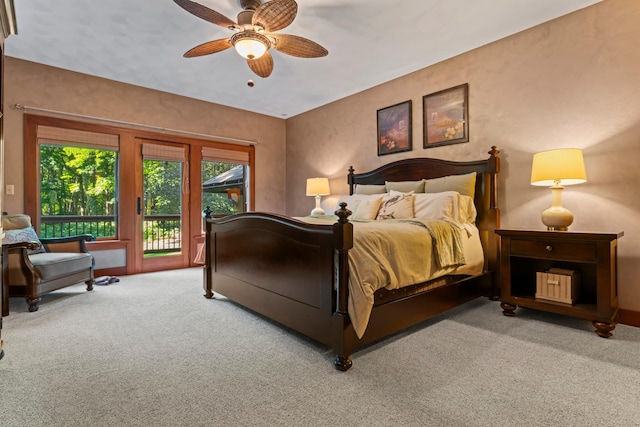 bedroom featuring access to exterior, ceiling fan, and light colored carpet