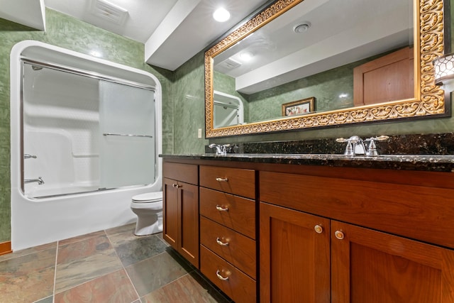 full bathroom with combined bath / shower with glass door, vanity, and toilet