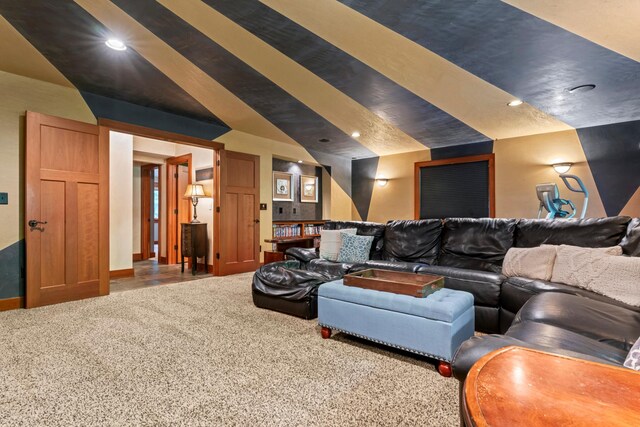 home theater featuring carpet and lofted ceiling