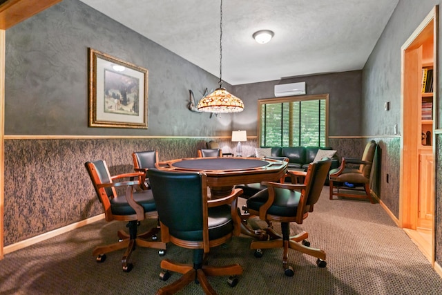 dining room with a textured ceiling, carpet floors, and an AC wall unit