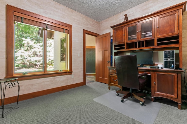 home office featuring a textured ceiling and carpet floors