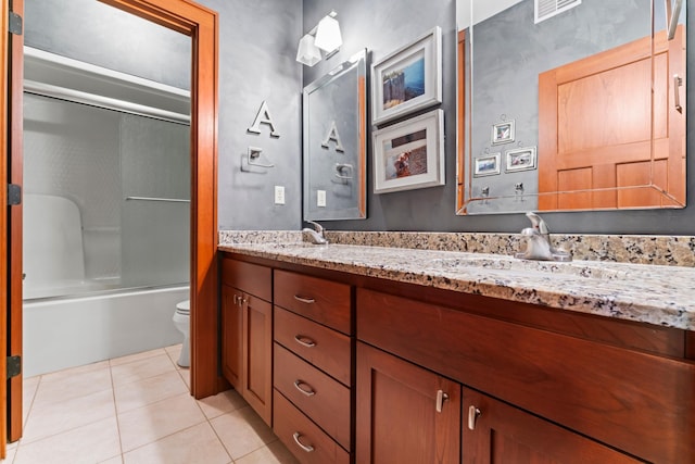 full bathroom with tile patterned flooring, vanity, bath / shower combo with glass door, and toilet