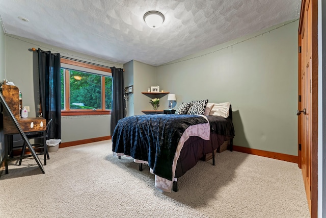 bedroom with carpet floors and a textured ceiling