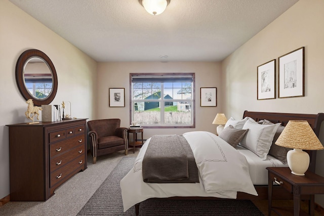 bedroom with light carpet and a textured ceiling