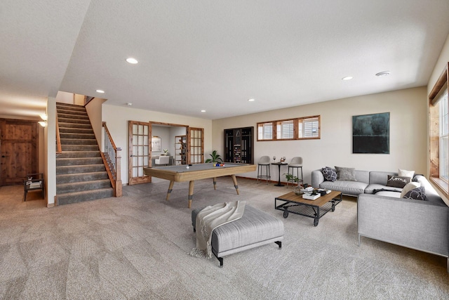 carpeted living area with recessed lighting, french doors, stairway, and a textured ceiling