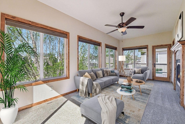 living room featuring ceiling fan, baseboards, and carpet floors