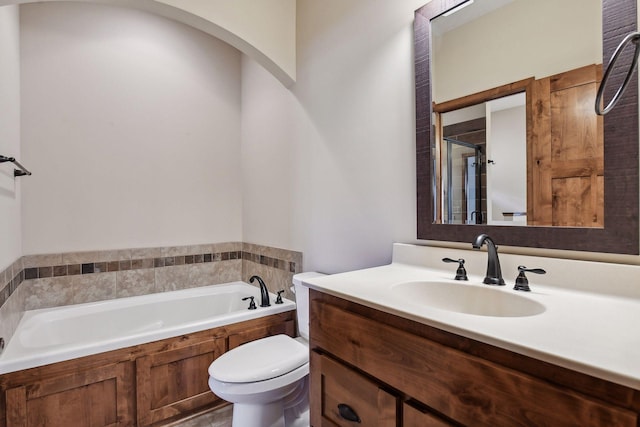 full bathroom with toilet, vanity, a stall shower, and a garden tub