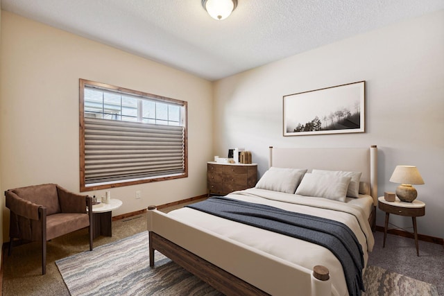 carpeted bedroom featuring a textured ceiling and baseboards