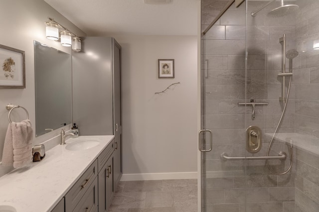 bathroom with tile patterned floors, vanity, and an enclosed shower