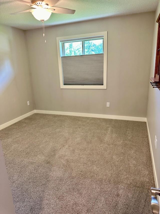 unfurnished room featuring carpet flooring, a textured ceiling, and ceiling fan